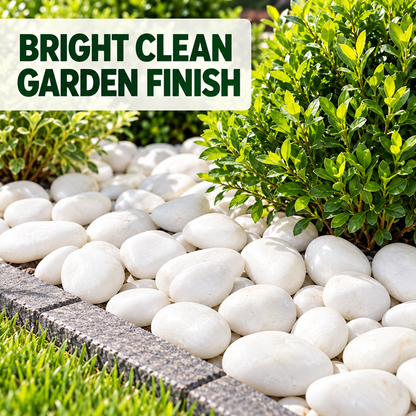 White decorative garden stones arranged in a landscaped bed beside green shrubs and grass, with a text banner reading “BRIGHT CLEAN GARDEN FINISH.”.
