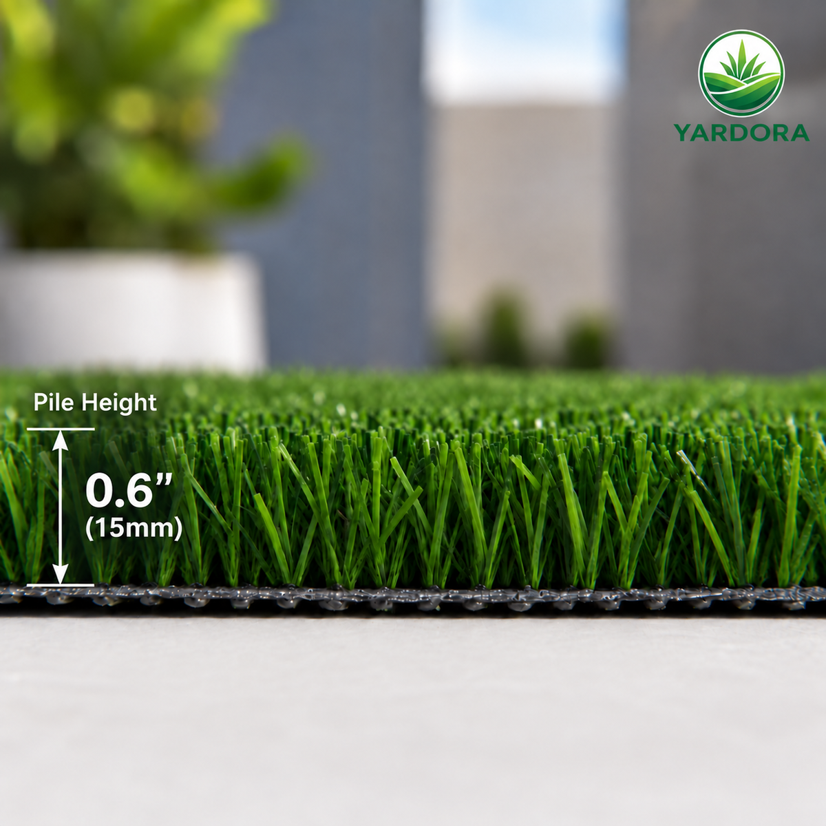 Close-up of green artificial turf with a black backing, showing a pile height of 0.6 inches (15mm).