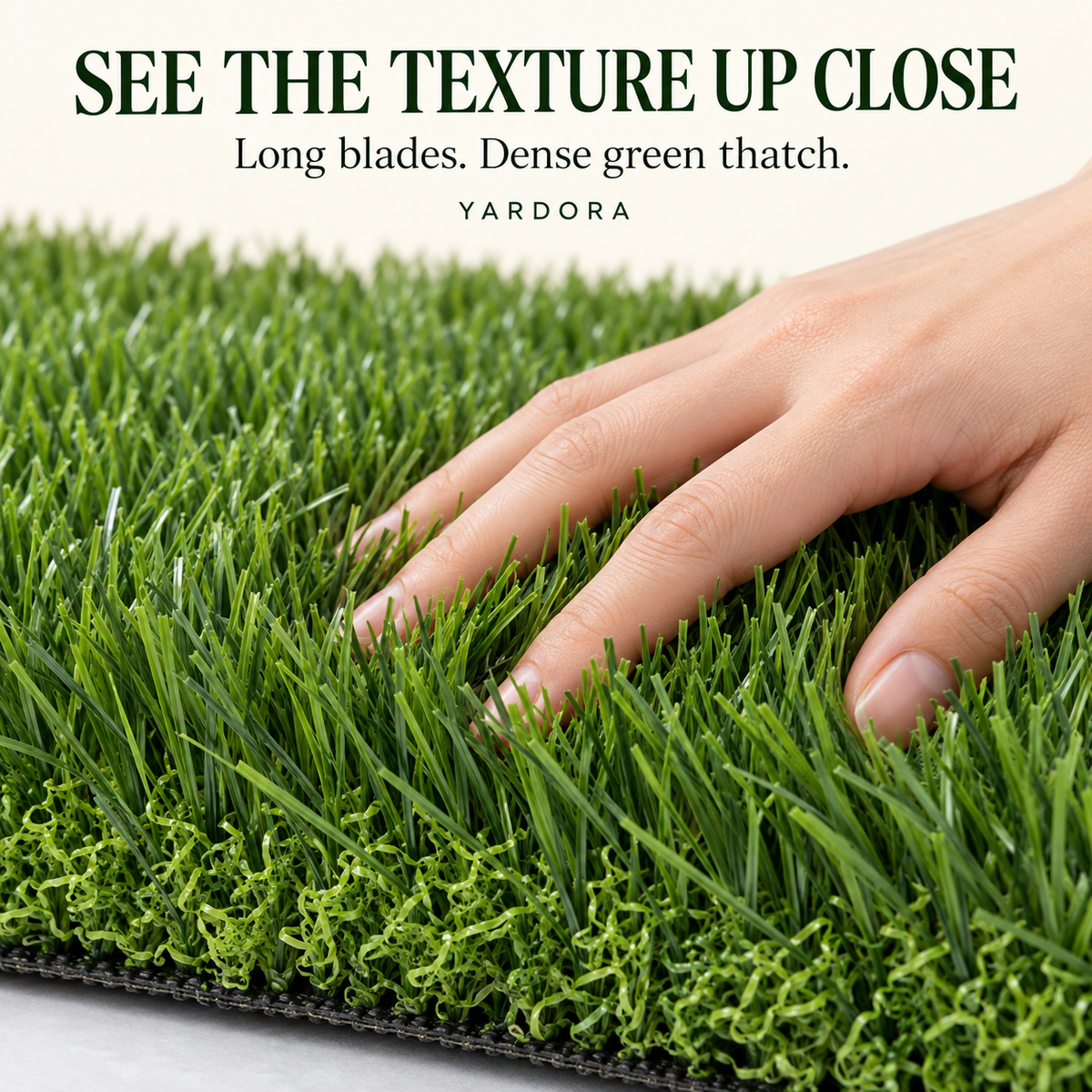 Close-up of a hand pressing into dense green artificial turf to show texture and blade detail, with text at the top reading 'SEE THE TEXTURE UP CLOSE. Long blades.